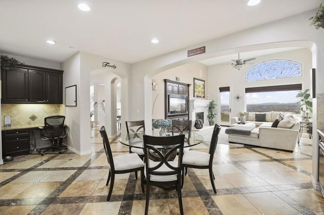 dining area featuring built in desk and ceiling fan