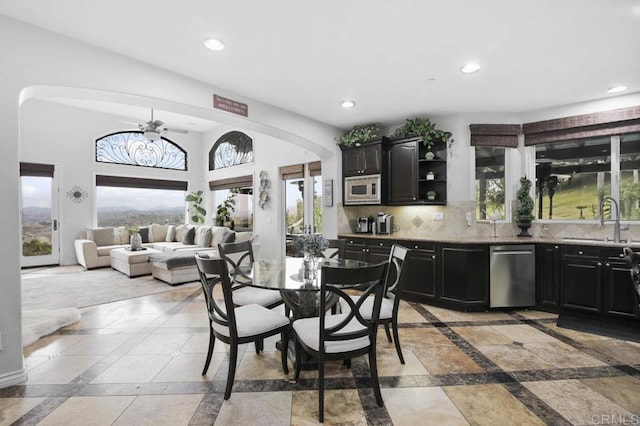 dining room with sink, a wealth of natural light, and ceiling fan