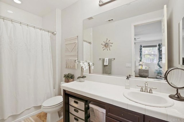 full bathroom with vanity, shower / tub combo, and toilet