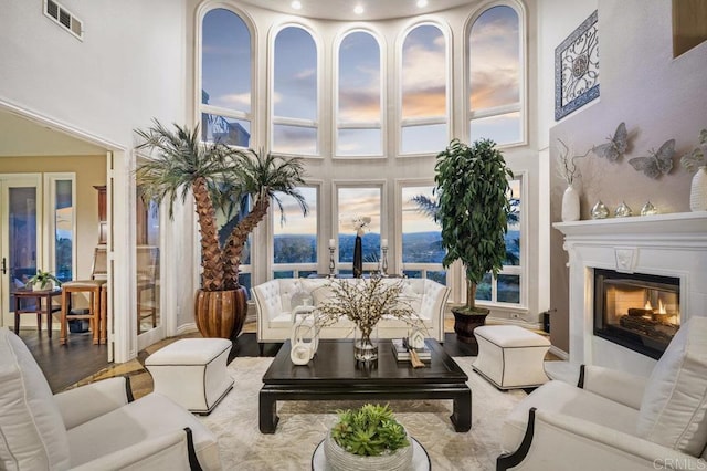 interior space with a towering ceiling and hardwood / wood-style floors