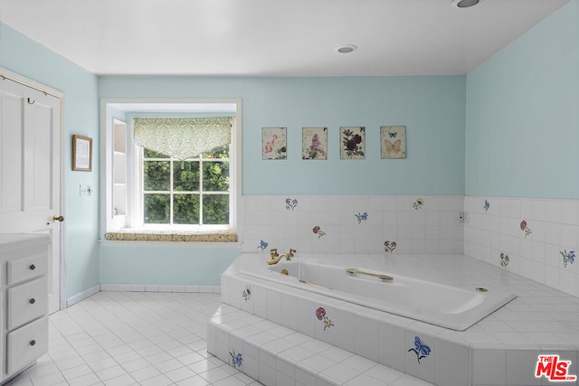 bathroom with tile patterned flooring and tiled bath