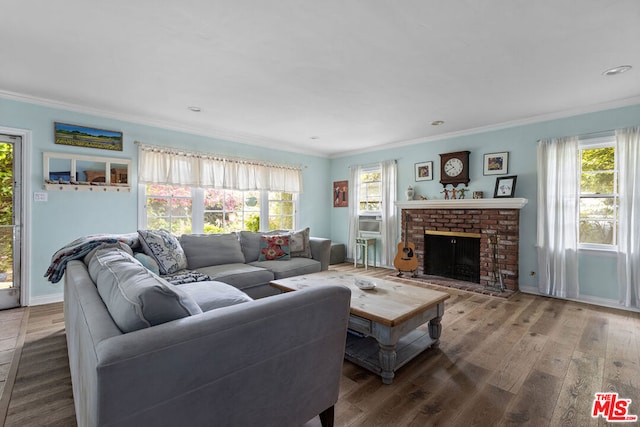 living room featuring crown molding, a brick fireplace, and hardwood / wood-style flooring