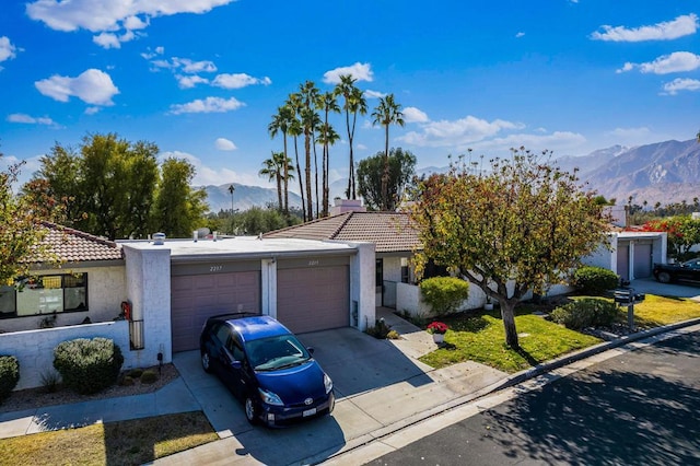 view of front of house featuring a mountain view and a garage