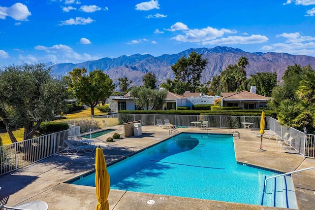 view of pool featuring a mountain view and a patio area