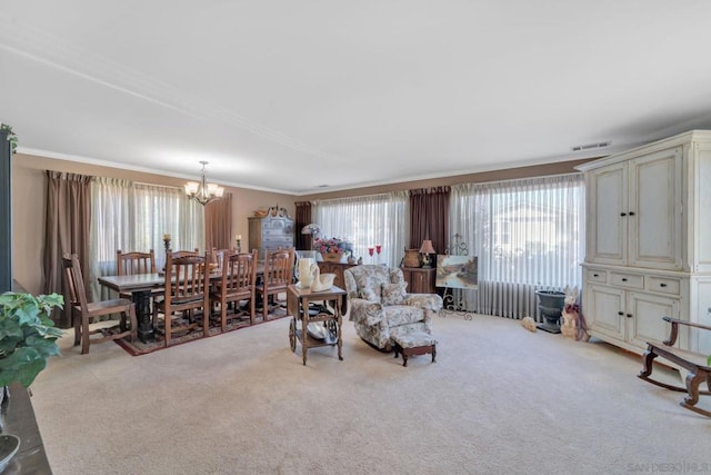 carpeted living room featuring crown molding and a notable chandelier