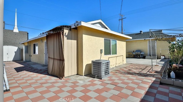 exterior space featuring central AC and a patio area