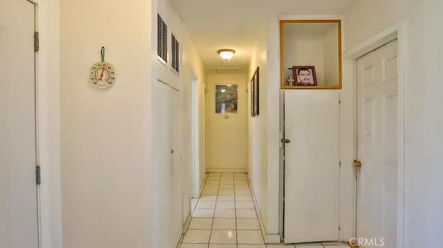 hall featuring light tile patterned flooring