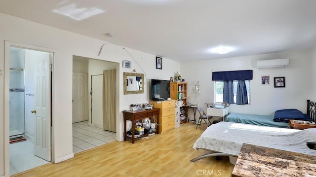 bedroom featuring wood-type flooring and an AC wall unit