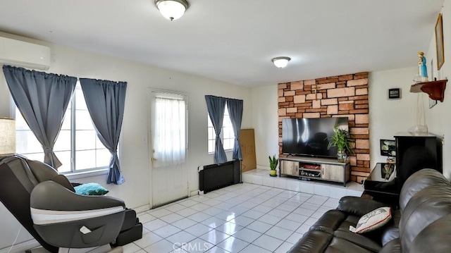 living room featuring light tile patterned flooring, plenty of natural light, and a wall unit AC