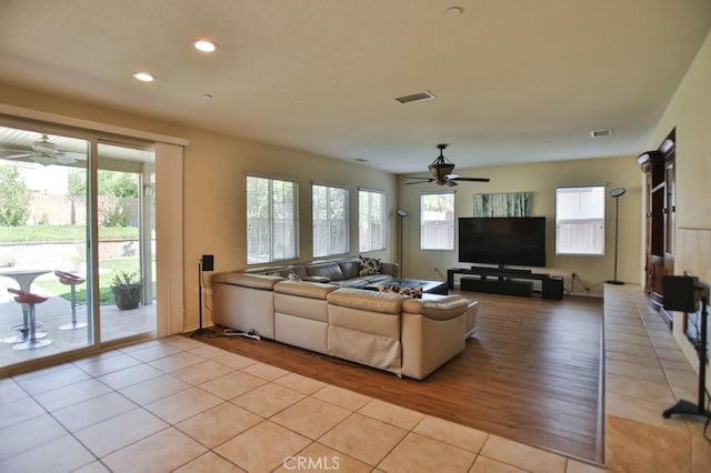 living room with light tile patterned flooring and ceiling fan