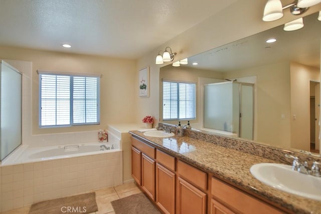 bathroom featuring tile patterned flooring, vanity, a healthy amount of sunlight, and plus walk in shower