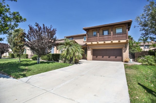 mediterranean / spanish house with a balcony, a garage, and a front lawn