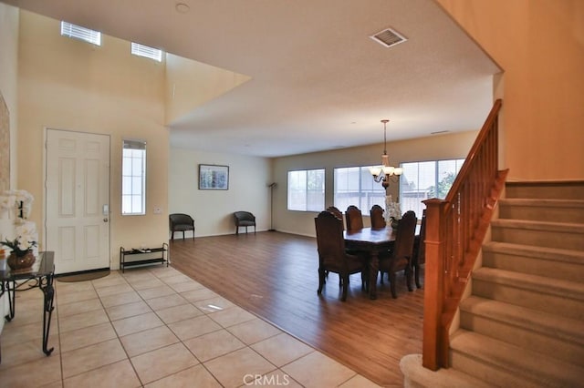 dining space with light tile patterned floors and a notable chandelier