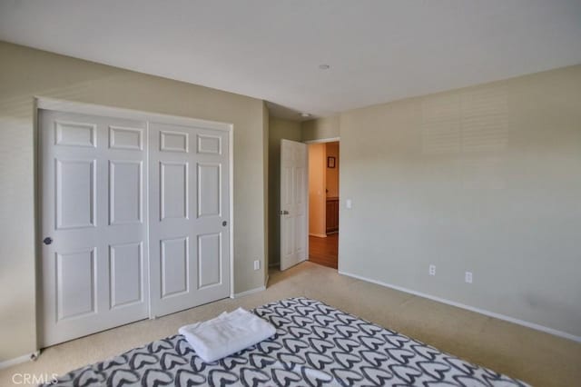 carpeted bedroom with a closet