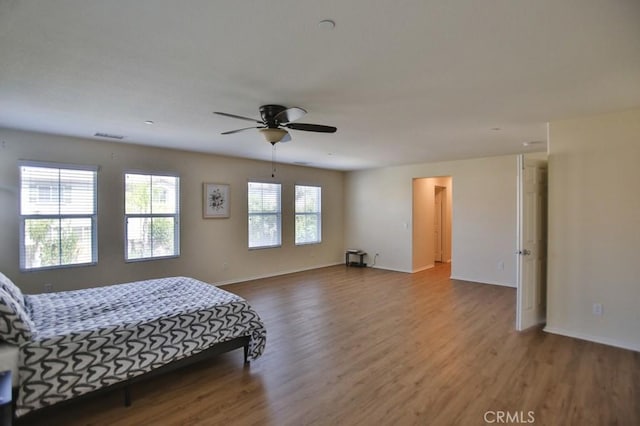 bedroom featuring hardwood / wood-style flooring and ceiling fan