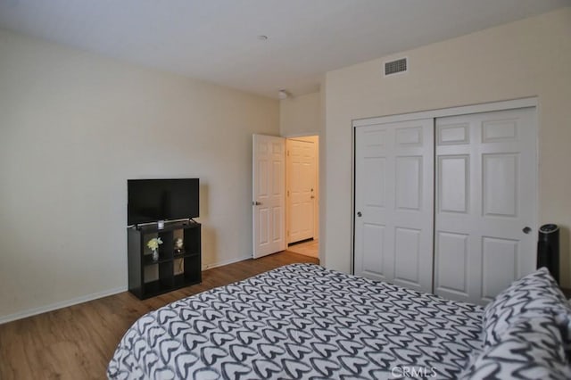 bedroom featuring wood-type flooring and a closet