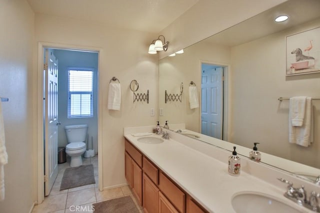 bathroom with vanity, toilet, and tile patterned flooring