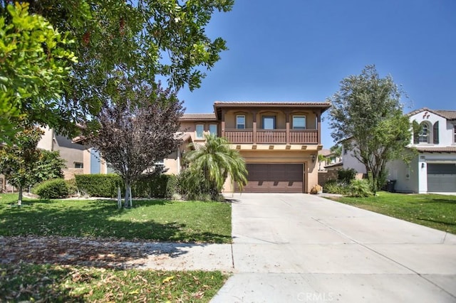 mediterranean / spanish-style house featuring a garage, a balcony, and a front yard