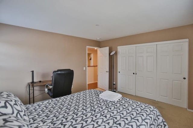 bedroom featuring light colored carpet and a closet