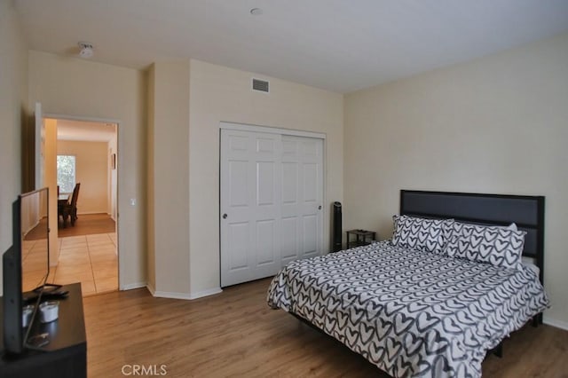 bedroom featuring light hardwood / wood-style flooring and a closet