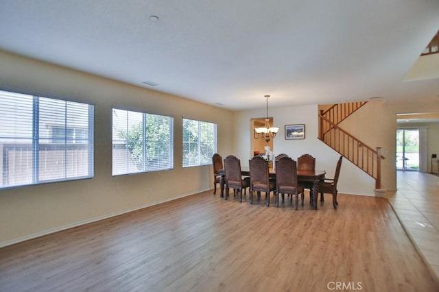 dining space featuring a chandelier and hardwood / wood-style floors