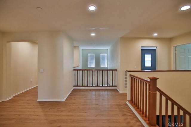 corridor with light hardwood / wood-style floors