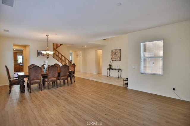 dining room featuring a chandelier and light wood-type flooring