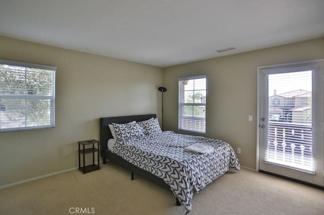 bedroom featuring light colored carpet and access to exterior