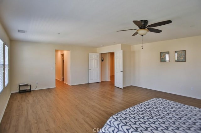 unfurnished bedroom with ceiling fan and light wood-type flooring