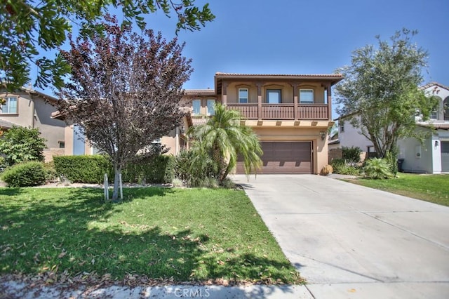 mediterranean / spanish-style house with a garage, a front lawn, and a balcony