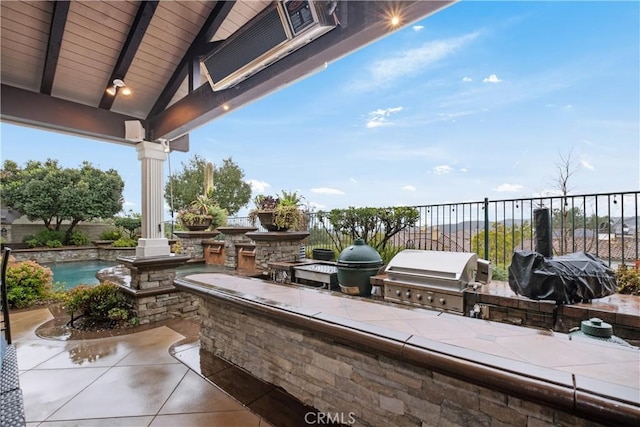 view of patio / terrace with area for grilling, a grill, exterior bar, and a fenced in pool