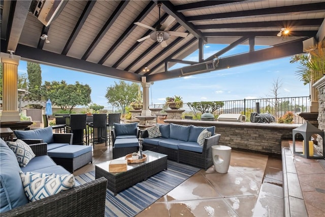 view of patio / terrace featuring a bar, an outdoor living space, a gazebo, and ceiling fan