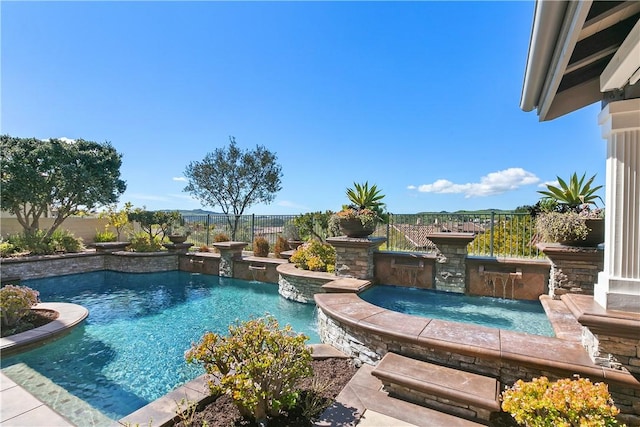 view of pool with an in ground hot tub and pool water feature