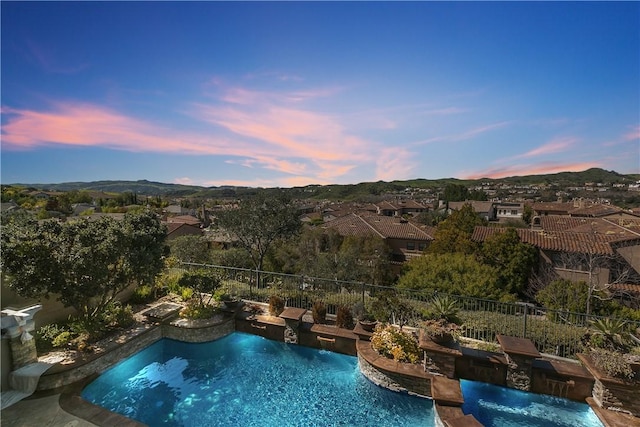 pool at dusk with pool water feature