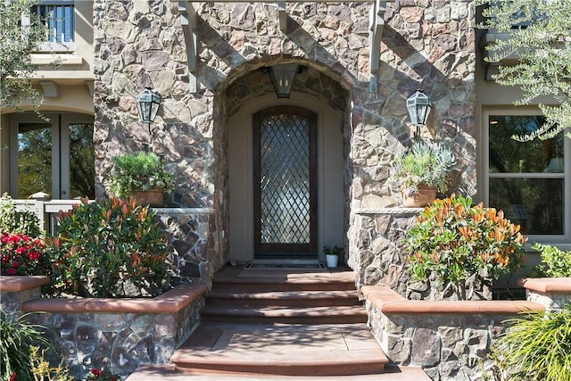 view of exterior entry featuring stone siding