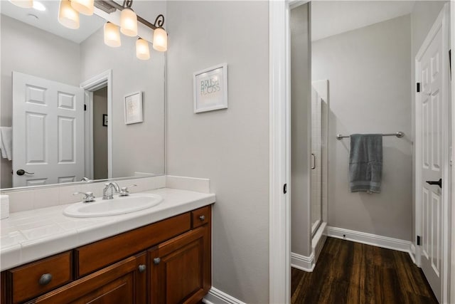 bathroom featuring wood-type flooring, vanity, and walk in shower