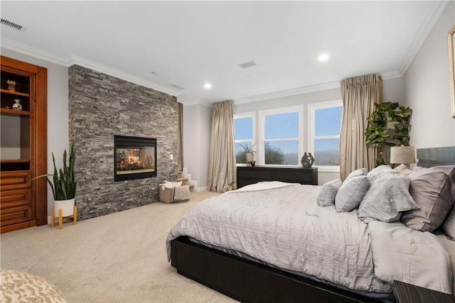 bedroom with crown molding, carpet, and a fireplace