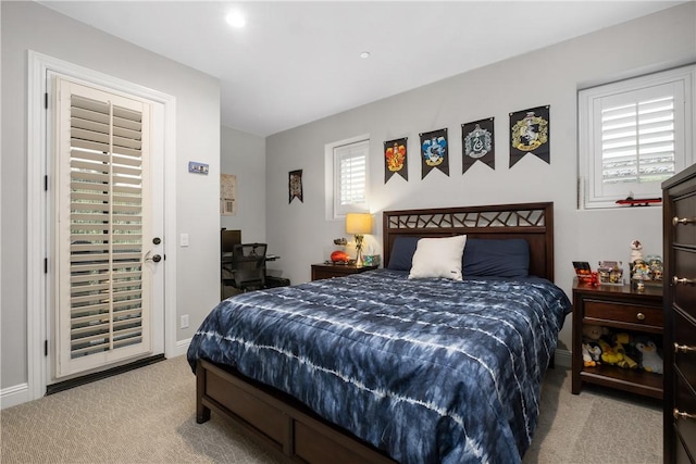 bedroom featuring access to outside and light colored carpet