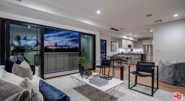 living room featuring light hardwood / wood-style flooring and baseboard heating