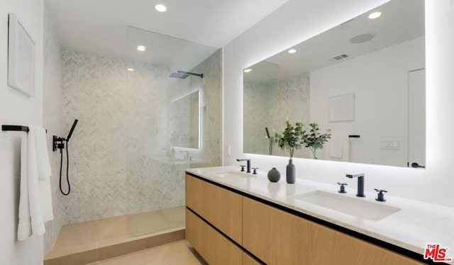 bathroom featuring vanity and tiled shower