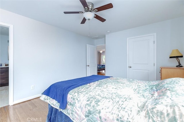 bedroom with ceiling fan and light hardwood / wood-style flooring