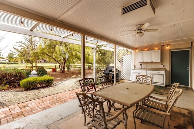 view of patio / terrace featuring ceiling fan, a grill, a pergola, and sink