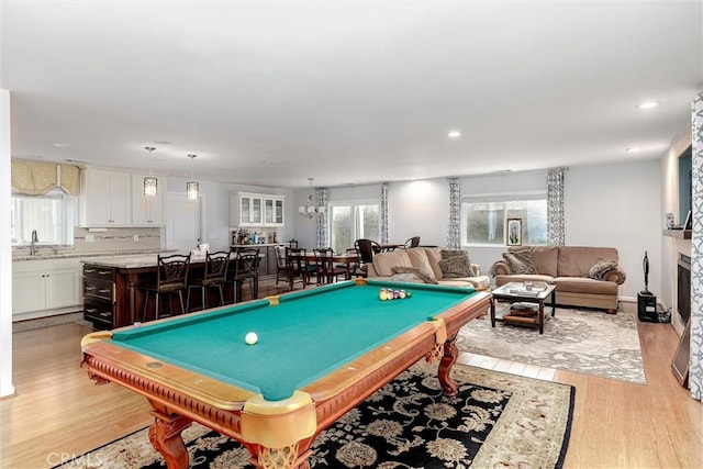 recreation room featuring sink, billiards, and light hardwood / wood-style flooring