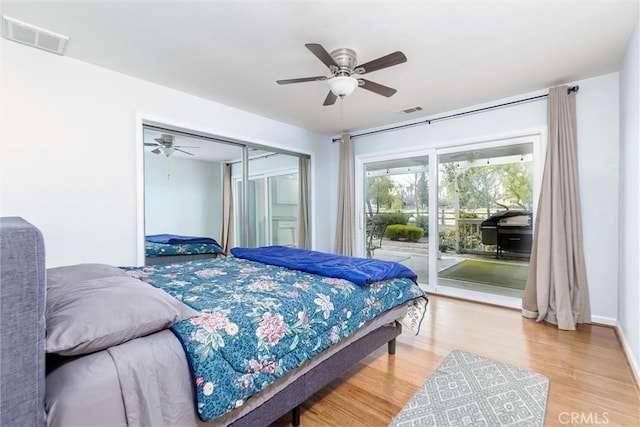 bedroom with hardwood / wood-style flooring, ceiling fan, a closet, and access to outside