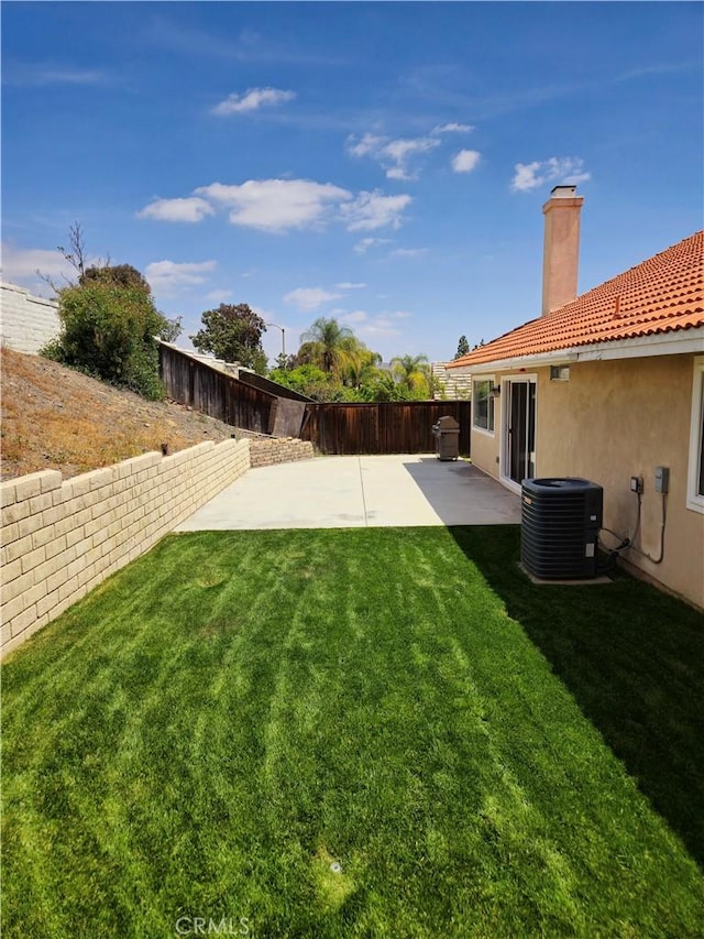 view of yard with central air condition unit, a fenced backyard, and a patio area