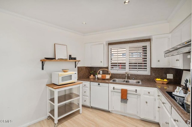 kitchen with tasteful backsplash, sink, white cabinets, crown molding, and white appliances