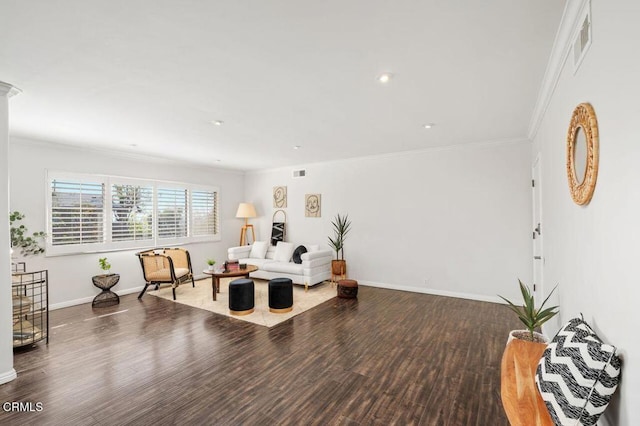 sitting room featuring wood-type flooring, ornamental molding, and ornate columns