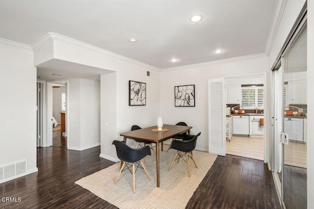 dining space featuring wood-type flooring and ornamental molding