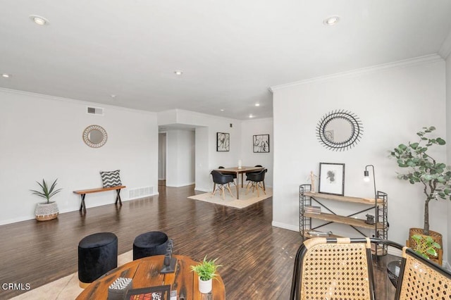 living room with ornamental molding and dark hardwood / wood-style floors