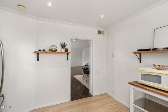 hallway featuring ornamental molding and light wood-type flooring